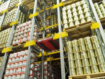An automated pallet shuttle system moving stored goods within high-density industrial racking.