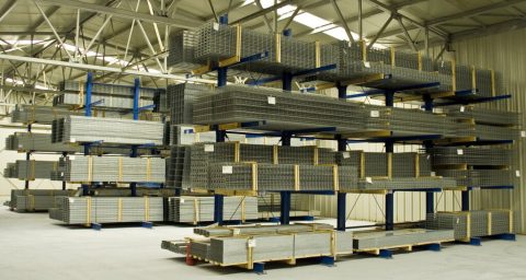Heavy-duty blue cantilever racking designed for storing long, bulky items like metal mesh and pipes.