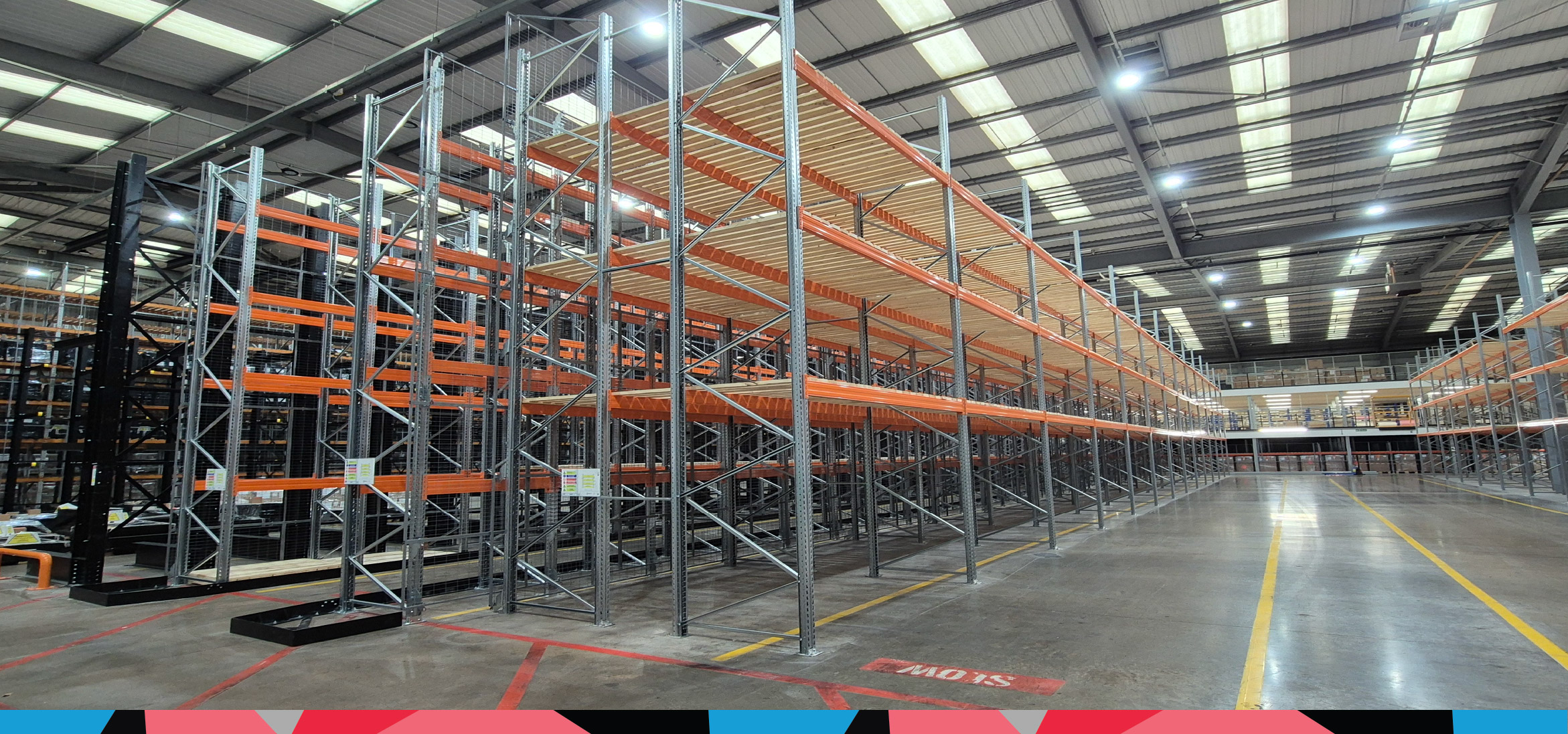 Warehouse with a new standard pallet racking system next to a heavy duty racking system
