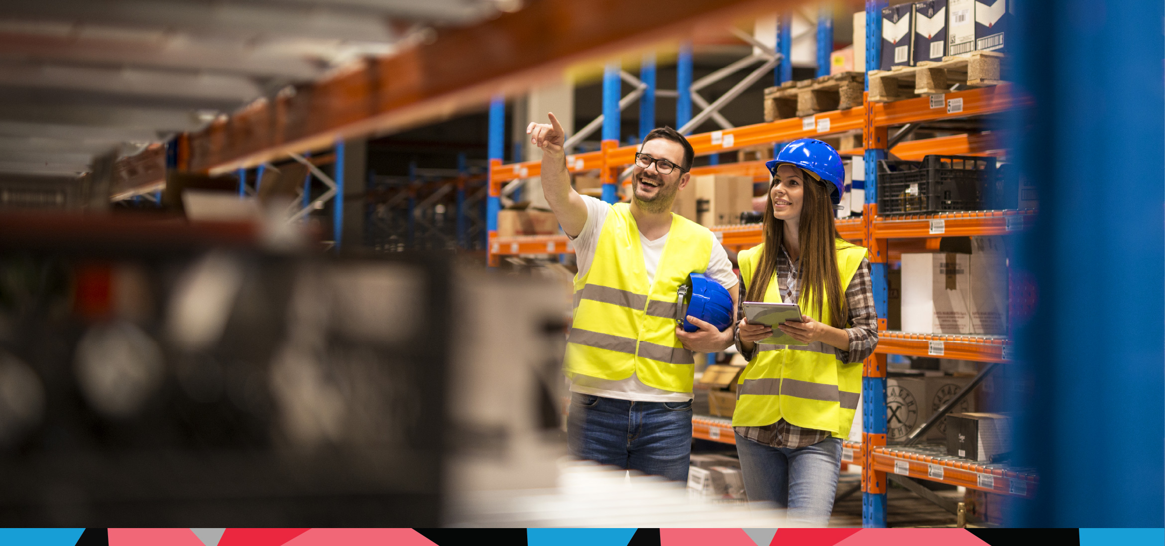 Two warehouse staff inspecting pallet racking to ensure compliance with UK health and safety regulations, including PUWER and HSWA requirements.
