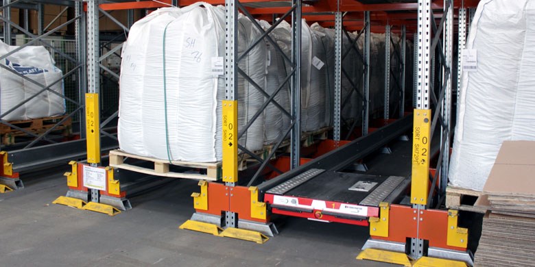 pallet shuttle at the pick face of a pallet shuttle system alongside bulk palletised goods.