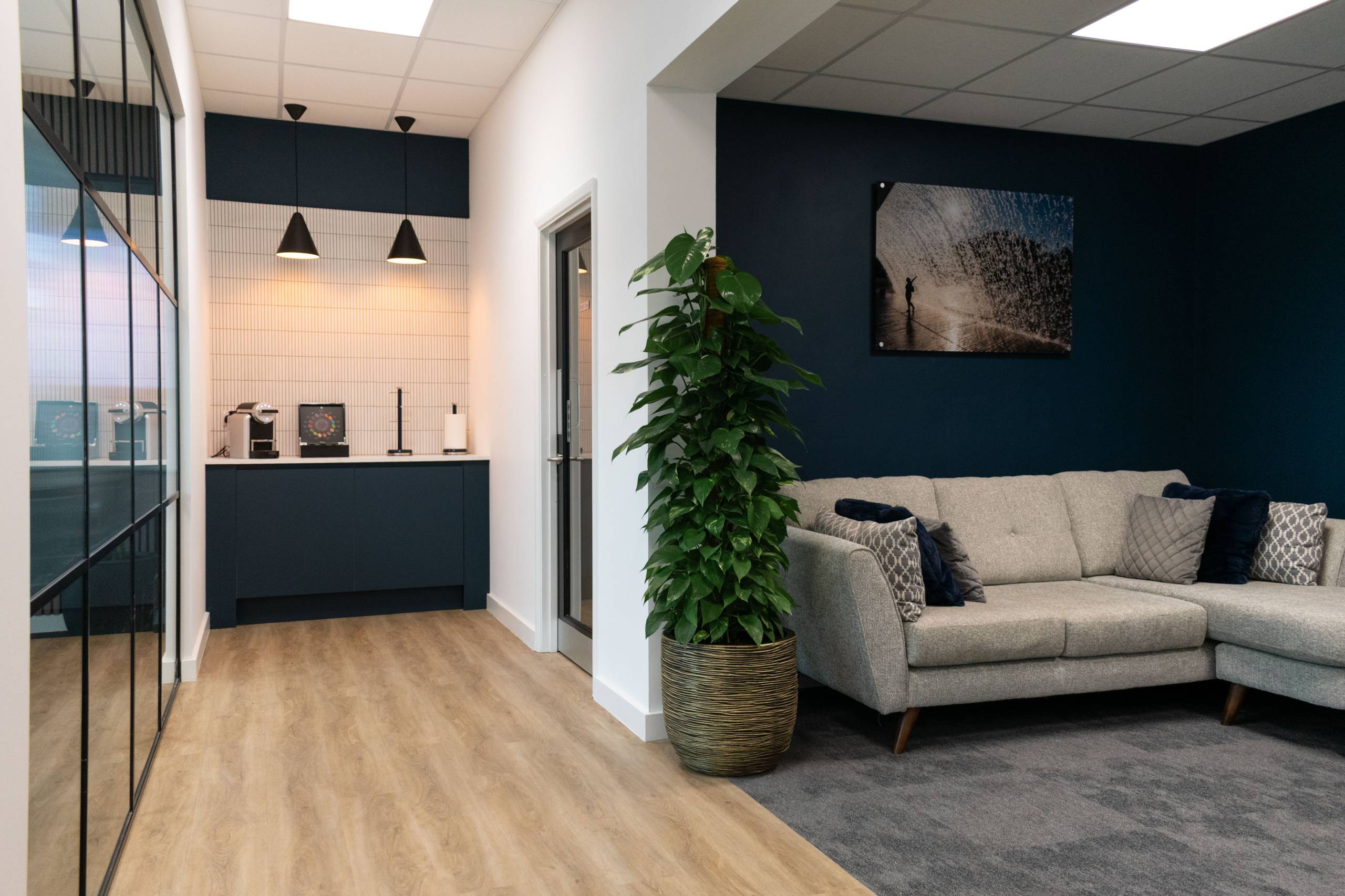Office breakout area with bar seating next to relaxed seating area