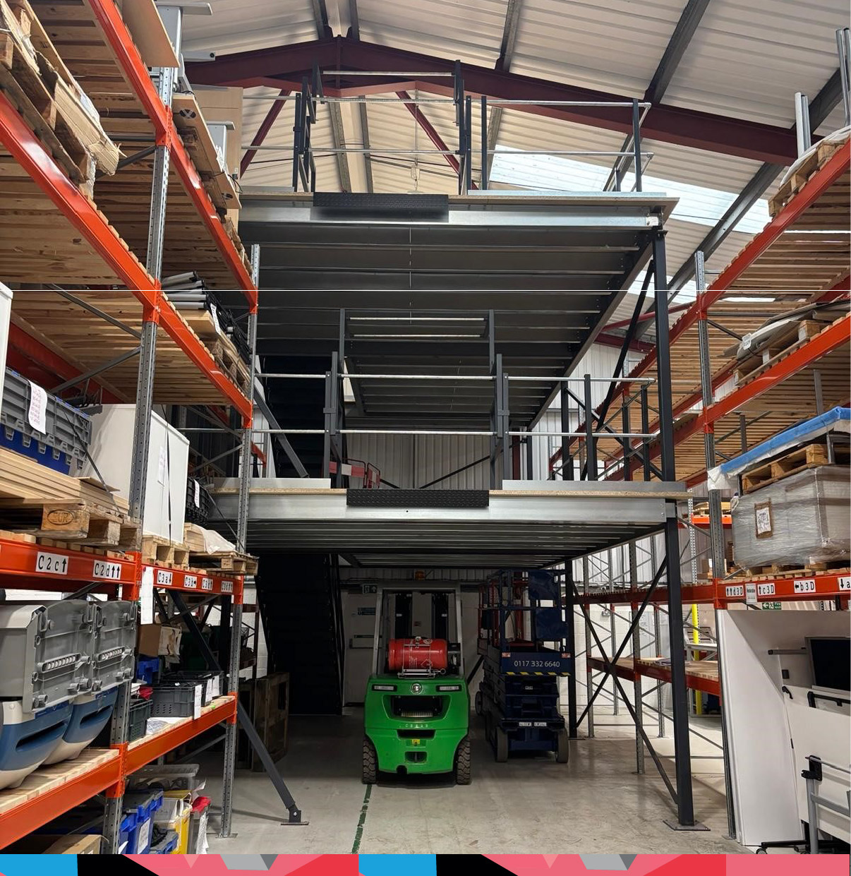 Multi-tier industrial mezzanine floor installed in a warehouse to increase storage space.