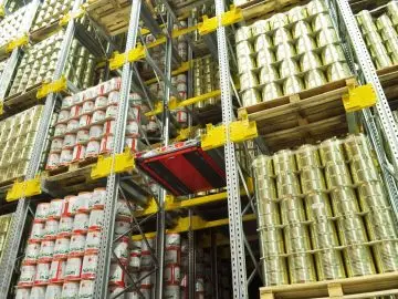 An automated pallet shuttle system moving stored goods within high-density industrial racking.