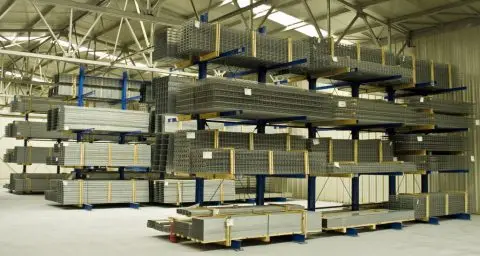 Heavy-duty blue cantilever racking designed for storing long, bulky items like metal mesh and pipes.